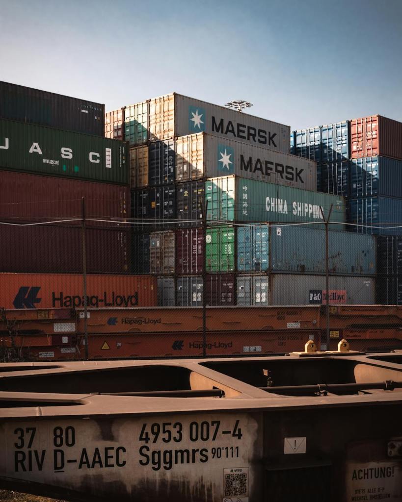stacks of cargo containers under blue sky